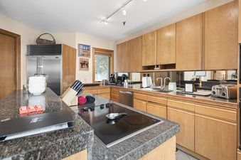 The kitchen at Abode at Highpoint features granite countertops and stainless steel appliances.
