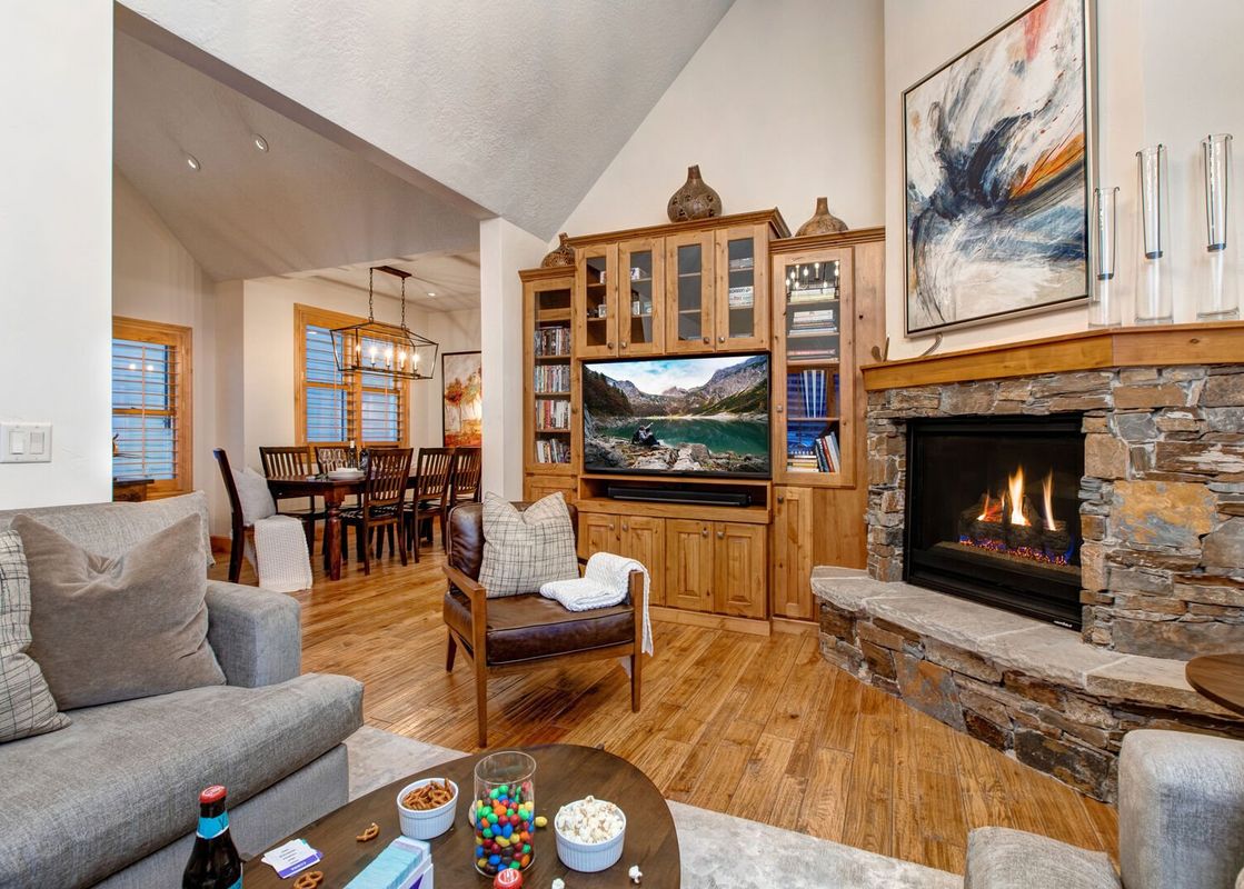The living area of Winter Mooring Old Town features a cozy fireplace and comfortable seating.