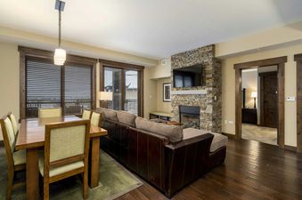 Trailhead Lodge 4115 features a spacious living area with a fireplace and large windows.