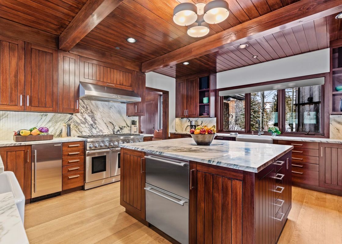The kitchen in Abode on the Big Trail features beautiful wood finishes and modern appliances.