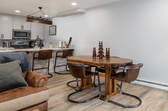 A modern kitchen and dining area with a rustic touch in Silverado I A101.