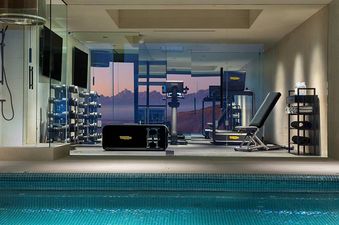 The Reflection Suite Yellowstone features a modern gym with a mountain view, an indoor pool, and a shower area, all designed for luxury and comfort.