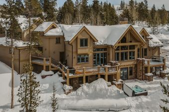 Exterior view of Mont Vista Chateau nestled in a snowy mountain landscape.