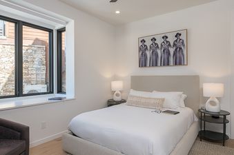 The bedroom at Spotted Saddle Lodge features a comfortable bed, stylish decor, and ample natural light.