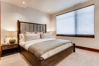 A cozy bedroom at Riverfront Townhome 13 features a plush bed and a relaxing ambiance.