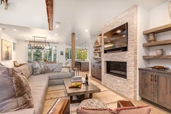 Modern living room with a stone fireplace and a large sectional sofa