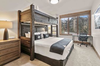 A beautifully decorated bedroom with a custom bunk bed.