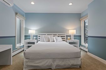 The bedroom at Pinnacle 1688 features soothing colors and bright light.
