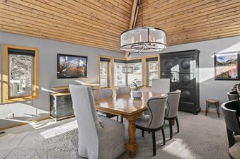 Dining room at 2060 Solamere Drive with a wooden table and gray chairs.