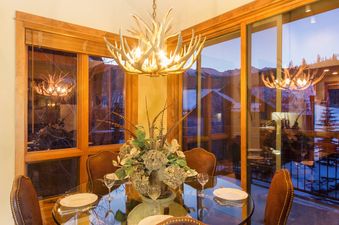 Terraces 602 dining table with chairs and a window with an exterior view of the mountains.