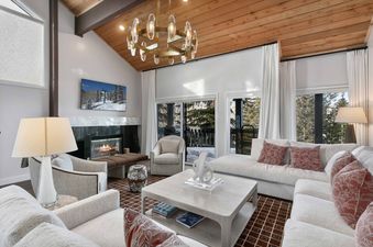 Ridgepoint Condos 105 living room featuring a fireplace, plush seating, and natural light.
