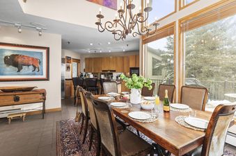 A dining room and kitchen area are ready for guests at Abode at Highpoint.