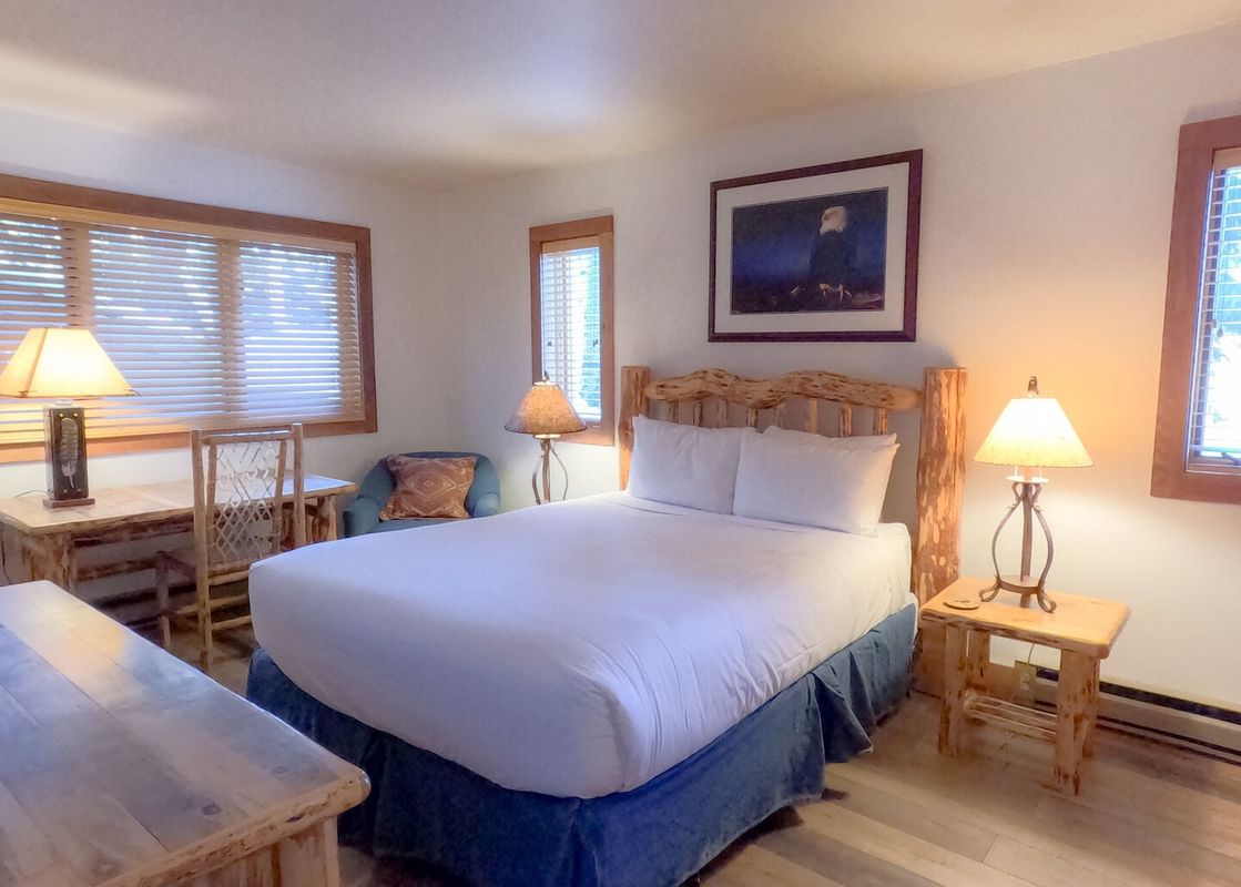 A cozy bedroom at Nez Perce D1 featuring a rustic log bed and natural wood furnishings.