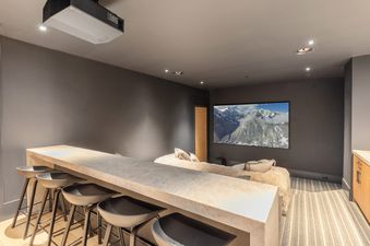 The movie room at Lone Star Lodge offers a cinematic experience with comfortable seating and a large screen.