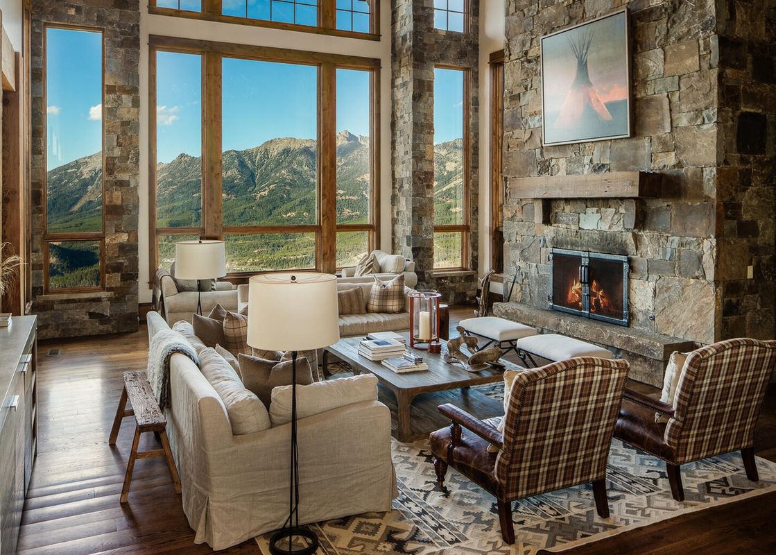The living area at 30 Spur Road Moonlight Basin has a large fireplace and a view of the mountains.