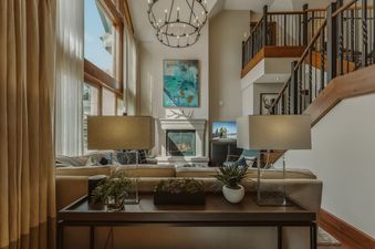 Living room at Eagles Nest at the Ritz-Carlton with fireplace and staircase.