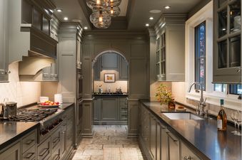 A modern, olive green galley kitchen inside Smoky Hollow.