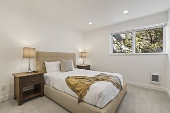 A cozy bedroom at Abode in Red Pine offers a tranquil retreat with its plush bedding and natural light.