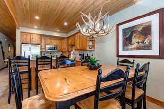 A dining room table is surrounded by chairs in this lovely space at Bristlecone Deer Valley.