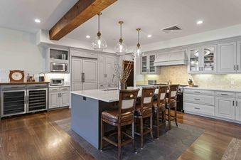 A modern kitchen at Silver Strike Lodge 705 with a large island, gray cabinetry, high-end appliances, and elegant lighting.
