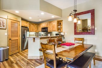 Dining table and kitchen area in EagleRidge Lodge 306