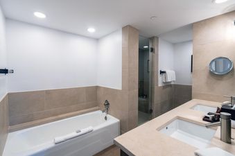 The Peaks Penthouse 434 boasts two sinks in the bathroom with granite countertops. The bathroom also features a large soaking tub.