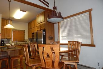 The kitchen and dining area of Beaver Village 131 with wooden furnishings.