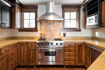 The kitchen in Silver Star 404 features a stainless steel Viking range, granite countertops, and wooden cabinetry.