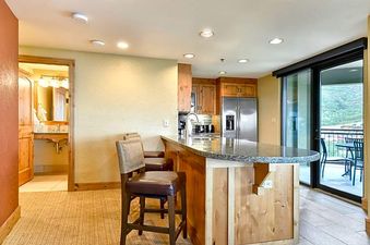 The Grand Summit Lodge Studio Residence features a spacious kitchen and a private balcony overlooking the mountains.