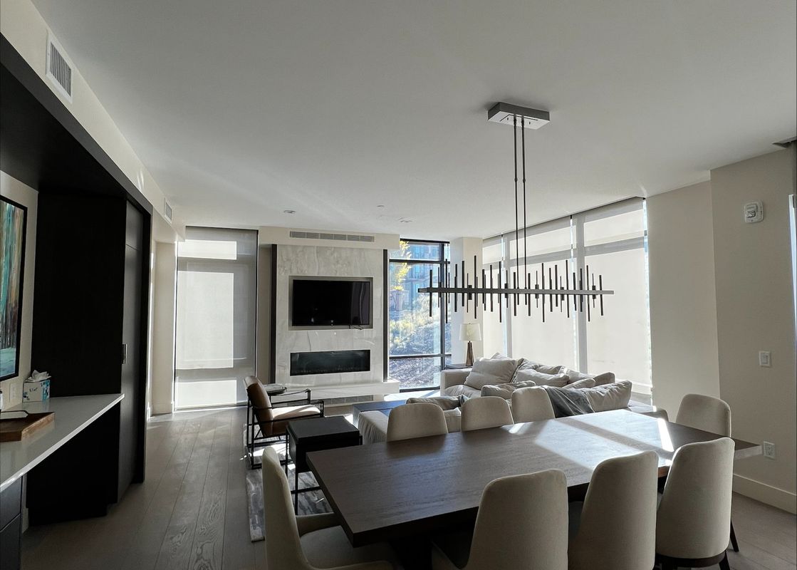 Modern open-concept dining and living room inside the Lift 4 Bedroom Suite.
