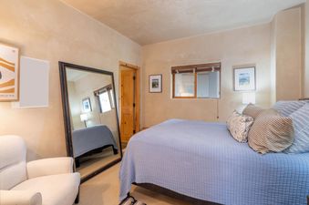 The Westermere 411 bedroom is decorated with a mirror and neutral colors.