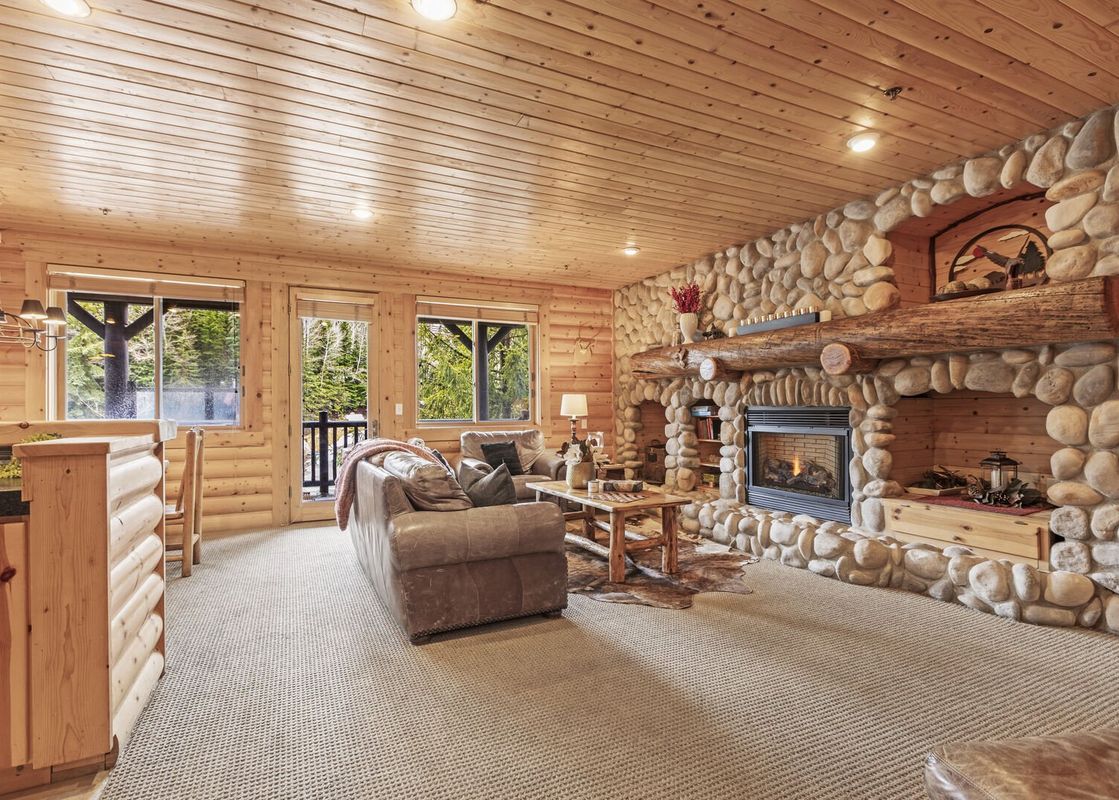 The living room of Black Bear 207 features a cozy fireplace and comfortable seating.