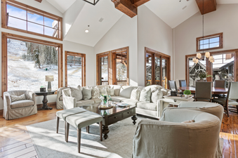 The living room of Grand Lodge Five Bedroom 402 features a large sectional sofa, a coffee table, two armchairs, and two ottomans.