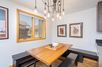 The dining area at Lulu City 5D features a wooden table with benches.