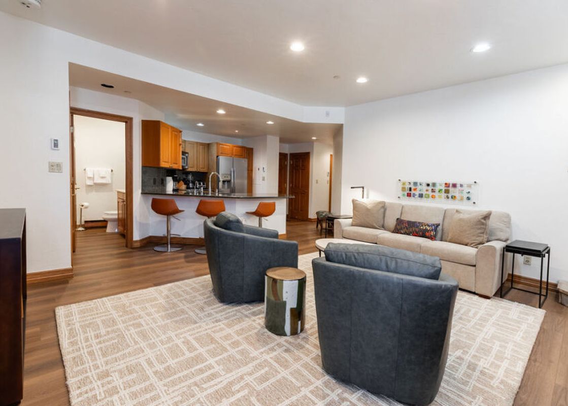 The living area of Strawberry Park 305 features comfortable seating, a flat-screen television, and a cozy fireplace, creating an inviting atmosphere for relaxation and entertainment.