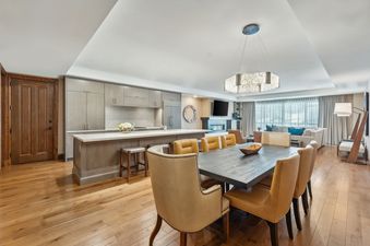 The dining area and kitchen of the St Regis 2 Bedroom Snow Park, featuring elegant furnishings and modern appliances.