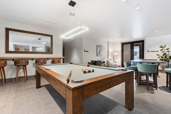 Riverfront Lodge features a games room with a pool table and seating area off the lobby.