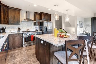 The kitchen in Abode at Queen Esther features a large island with bar seating.