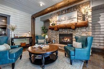The inviting living area in Black Bear 201 with comfortable seating and a stone fireplace.