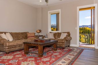 Cozy living area of Peak View Paradise with leather sofas and scenic mountain views.