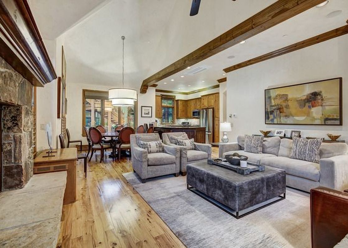 The living area features a large fireplace, comfortable seating, and a dining area, offering a warm and inviting atmosphere.