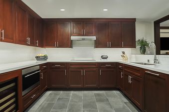 The contemporary kitchen in Montage Alpine Residential Suite features rich wooden cabinetry, light countertops, and modern appliances.