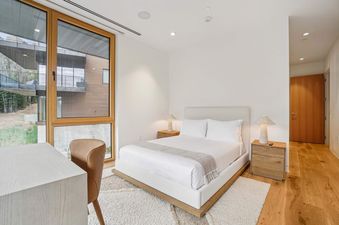 A Founders Place 2401's bedroom with a large window and a comfortable bed with white bedding.