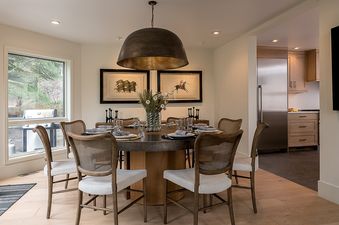 Dining area with round table and seating at Ethereal Lodge.