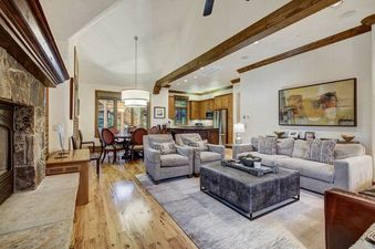 The living area features a large fireplace, comfortable seating, and a dining area, offering a warm and inviting atmosphere.