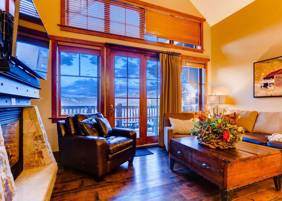 Living room at One Ski Hill Penthouse with leather furniture and a view.