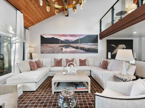 The living room of Ridgepoint Condos 105 features a large sectional sofa and a statement art piece.