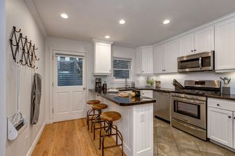 The kitchen in Abode at Watson House has a cozy breakfast bar.
