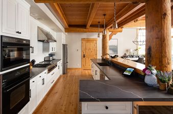 The gourmet kitchen in Moonlight Basin Penthouse 1 features top-of-the-line stainless steel appliances, sleek cabinetry, and a spacious countertop.