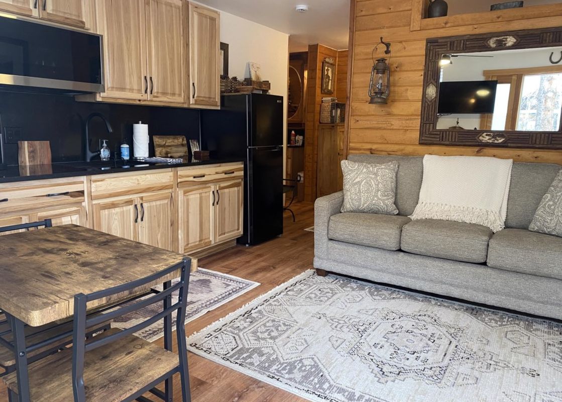 The cozy living area of Tomboy Lodge 138 features a comfortable couch and warm decor.